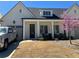 Charming home with white columns, a well-manicured lawn, and a blooming tree at 5099 Noble Village Way, Lilburn, GA 30047