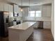 Modern kitchen featuring white cabinetry, stainless steel appliances, and a center island at 5099 Noble Village Way, Lilburn, GA 30047