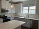 Bright kitchen featuring white cabinetry, stainless steel appliances, and ample counter space at 5099 Noble Village Way, Lilburn, GA 30047
