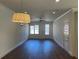 Spacious living room filled with natural light, featuring wood floors and modern ceiling fan at 5099 Noble Village Way, Lilburn, GA 30047