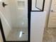 Modern shower with glass doors, white subway tile, and stylish fixtures at 5099 Noble Village Way, Lilburn, GA 30047