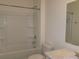Clean bathroom featuring a shower-tub combo and a marbled vanity at 120 Montgomery Dr, Stockbridge, GA 30281