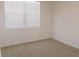 Bright bedroom featuring neutral carpet, blinds, and fresh paint at 120 Montgomery Dr, Stockbridge, GA 30281