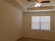 Bright bedroom featuring large window, tray ceiling, and modern ceiling fan at 120 Montgomery Dr, Stockbridge, GA 30281