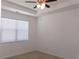 Cozy bedroom with large window, neutral color palette, and ceiling fan at 120 Montgomery Dr, Stockbridge, GA 30281