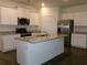 Modern kitchen boasting granite counters, stainless appliances, white cabinetry, and a central island at 120 Montgomery Dr, Stockbridge, GA 30281