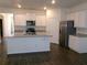 Modern kitchen with stainless steel appliances and granite countertops island at 120 Montgomery Dr, Stockbridge, GA 30281