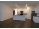 Bright kitchen featuring white cabinets, granite countertops, stainless appliances, and a large island at 120 Montgomery Dr, Stockbridge, GA 30281