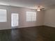 Bright living room with hardwood floors, modern ceiling fan and ample natural light at 120 Montgomery Dr, Stockbridge, GA 30281