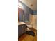 A blue-walled bathroom includes a shower stall, standard toilet, vanity, and a tiled floor at 45 James P Brawley Nw Dr, Atlanta, GA 30314