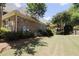 A serene backyard with manicured lawn, mature trees, and an iron fence at 1520 Camden Cove Dr, Cumming, GA 30040