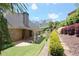 Lush backyard featuring a covered patio, well-maintained lawn, and beautiful landscaping with retaining walls at 1520 Camden Cove Dr, Cumming, GA 30040