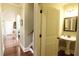 Half bathroom with hardwood floors, a pedestal sink, and a framed mirror by stairway landing at 1520 Camden Cove Dr, Cumming, GA 30040