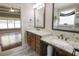 Bright bathroom featuring double vanity with granite countertops and modern fixtures at 1520 Camden Cove Dr, Cumming, GA 30040
