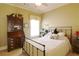 Bedroom featuring a bed with white bedding, dark furniture, and natural light at 1520 Camden Cove Dr, Cumming, GA 30040