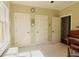 Sunlit bedroom boasting three doors, neutral carpet, and a comfortable window seat at 1520 Camden Cove Dr, Cumming, GA 30040