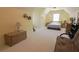 Spacious bedroom under a sloped ceiling with a bed, chair and wooden trunk at 1520 Camden Cove Dr, Cumming, GA 30040