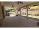 Covered patio with a brick retaining wall, patio furniture, and manicured landscaping at 1520 Camden Cove Dr, Cumming, GA 30040