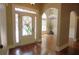 Elegant foyer with gleaming hardwood floors and a decorative glass front door at 1520 Camden Cove Dr, Cumming, GA 30040