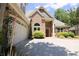 Beautiful brick home featuring a well-kept lawn, two-car garage, and attractive front entrance at 1520 Camden Cove Dr, Cumming, GA 30040