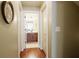 Hallway that leads to a bathroom with brown wood floors and white trim at 1520 Camden Cove Dr, Cumming, GA 30040