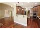 Open kitchen view with granite countertop, custom cabinets, and stainless steel appliances adjacent to the living room at 1520 Camden Cove Dr, Cumming, GA 30040