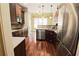 Bright kitchen with stainless steel appliances, custom wood cabinetry, granite countertop and island sink at 1520 Camden Cove Dr, Cumming, GA 30040