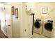 Well-lit laundry room with washer, dryer, and storage cabinets at 1520 Camden Cove Dr, Cumming, GA 30040