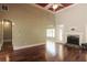 Bright living room featuring a fireplace, hardwood floors, ceiling fan and an arched doorway to other rooms at 1520 Camden Cove Dr, Cumming, GA 30040