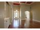 Spacious living room featuring gleaming hardwood floors and arched doorways at 1520 Camden Cove Dr, Cumming, GA 30040