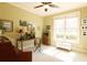 Cozy home office featuring a ceiling fan, large window, desk, decorative touches and neutral color scheme at 1520 Camden Cove Dr, Cumming, GA 30040