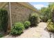 Charming sideyard featuring stone pavers, decorative gravel, and privacy landscaping with swing at 1520 Camden Cove Dr, Cumming, GA 30040