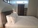 Bedroom featuring a comfortable bed with white patterned bedding, upholstered headboard, and side table at 215 Piedmont Ne Ave # 304, Atlanta, GA 30308