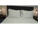 Bedroom featuring a comfortable bed with white patterned bedding, upholstered headboard, and side tables at 215 Piedmont Ne Ave # 304, Atlanta, GA 30308