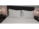 Bedroom featuring a comfortable bed with white patterned bedding, upholstered headboard, and side tables at 215 Piedmont Ne Ave # 304, Atlanta, GA 30308