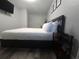 Stylish bedroom with sleek design, a mounted TV, and modern bedside table at 215 Piedmont Ne Ave # 304, Atlanta, GA 30308
