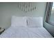 Bright bedroom featuring a comfy bed with white patterned bedding and tassel decoration above headboard at 215 Piedmont Ne Ave # 304, Atlanta, GA 30308