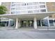 Inviting condominium building entrance featuring covered parking and glass doors at 215 Piedmont Ne Ave # 304, Atlanta, GA 30308
