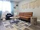 Cozy living area with leather seating, rug, and natural light from the window at 215 Piedmont Ne Ave # 304, Atlanta, GA 30308