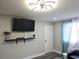 A modern living room featuring a mounted television and minimalist décor at 215 Piedmont Ne Ave # 304, Atlanta, GA 30308