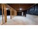 Unfinished basement with wooden framing, concrete floors, and black plastic lining at 7128 Crystal Creek Pl, Douglasville, GA 30134