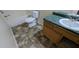 Bathroom featuring toilet, tub with shower, and sink with wood cabinet at 7128 Crystal Creek Pl, Douglasville, GA 30134