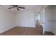 Bright bedroom featuring hardwood floors, a ceiling fan, and an adjacent walk-in closet at 7128 Crystal Creek Pl, Douglasville, GA 30134