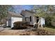 Charming home featuring a two-car garage, a well-manicured lawn, and mature trees at 7128 Crystal Creek Pl, Douglasville, GA 30134