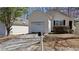 Charming home featuring a two-car garage, a well-manicured lawn, and mature trees at 7128 Crystal Creek Pl, Douglasville, GA 30134