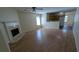 Spacious living room and kitchen with hardwood floors and a classic fireplace at 7128 Crystal Creek Pl, Douglasville, GA 30134