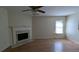 Bright living room features wood floors, fireplace and ceiling fan with light at 7128 Crystal Creek Pl, Douglasville, GA 30134