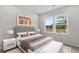 Inviting bedroom with a large window, plush bedding, and neutral color scheme at 841 Pineberry Ct, Grayson, GA 30017