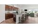 Modern kitchen features dark wood cabinets, granite countertops, stainless steel appliances, and a spacious island at 841 Pineberry Ct, Grayson, GA 30017