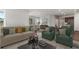 Bright open-concept living area features stylish furniture, neutral decor, and seamlessly connects to the dining and kitchen at 841 Pineberry Ct, Grayson, GA 30017